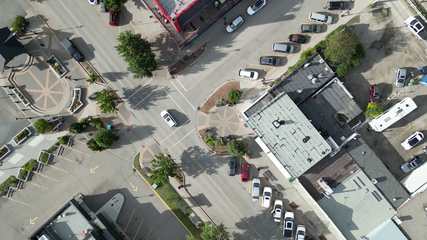 1st Street West straight down: angled stalls, crosswalks and the brick circles set into the sidewalk