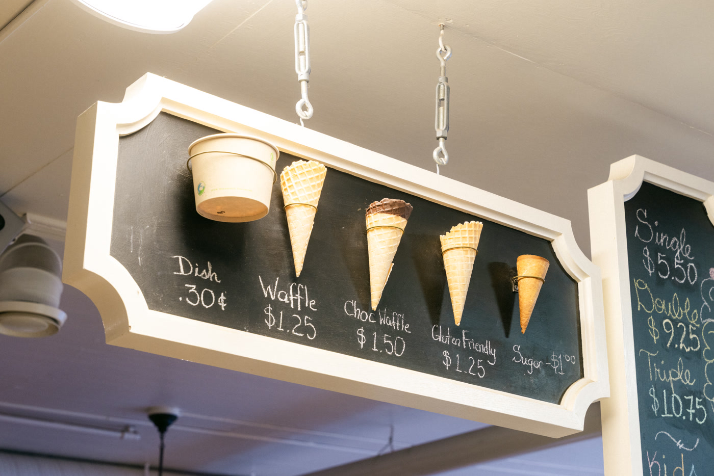 The cone board hung from the ceiling on turnbuckles: a dish, a waffle cone, a chocolate waffle, a gluten-free cone and a sugar cone pinned to black chalkboard, each priced beneath
