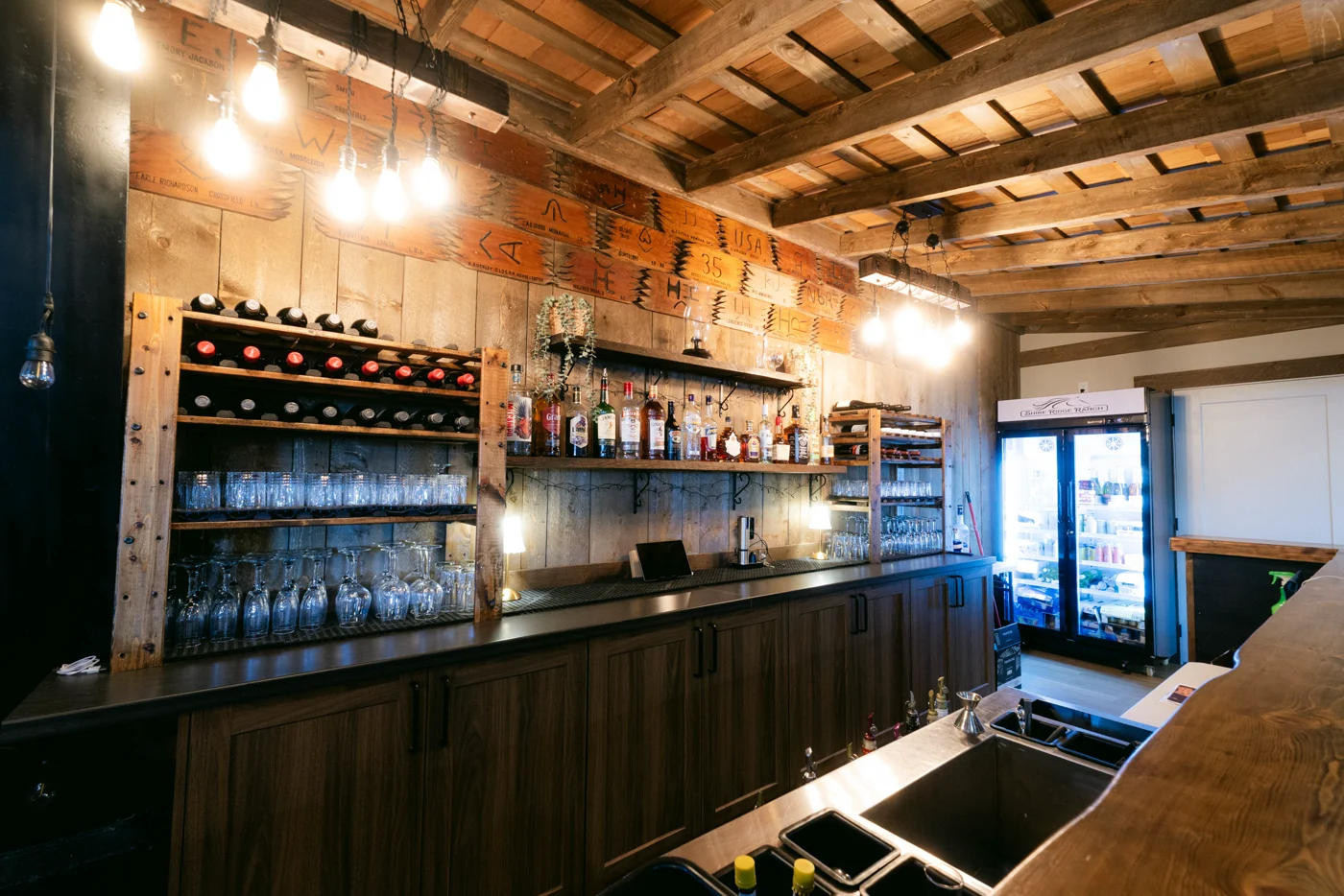 Bottles, glassware and shelves behind the bar of an event hall