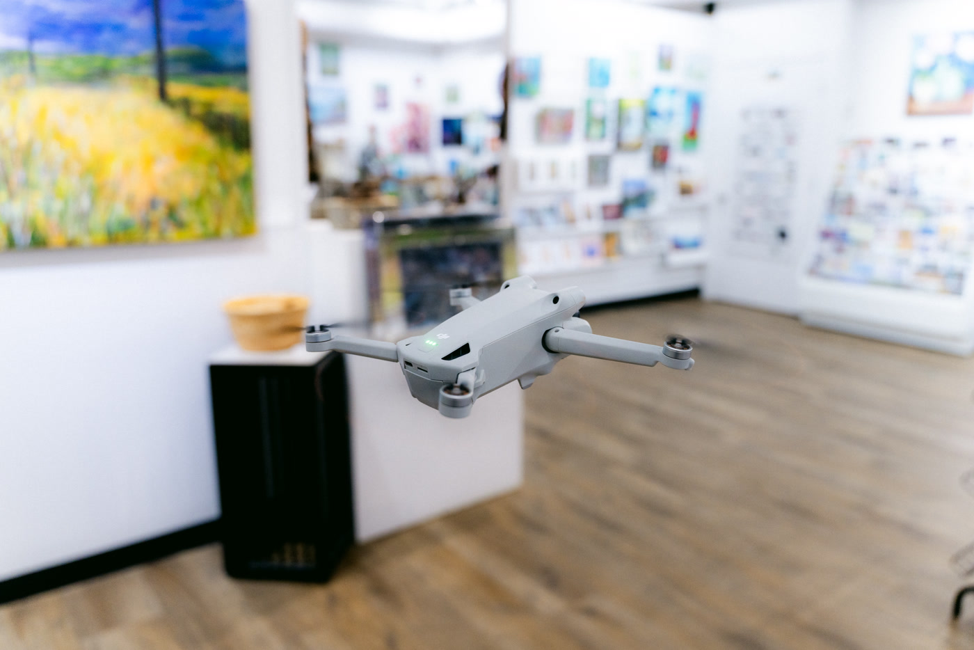 The aircraft in mid-air beside a white plinth holding a turned wooden bowl at Route 22