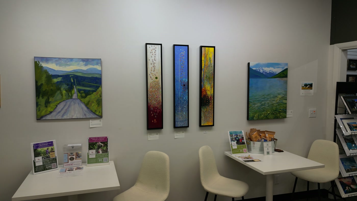 Tables and moulded chairs in the Route 22 Makerspace, beneath a painted road and three tall panels