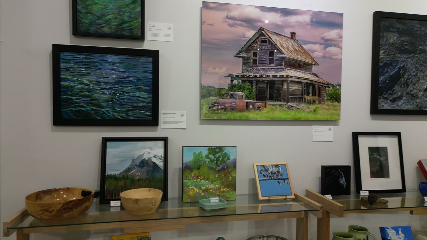 The hung wall at Route 22 Art Gallery, a small white card beside each piece