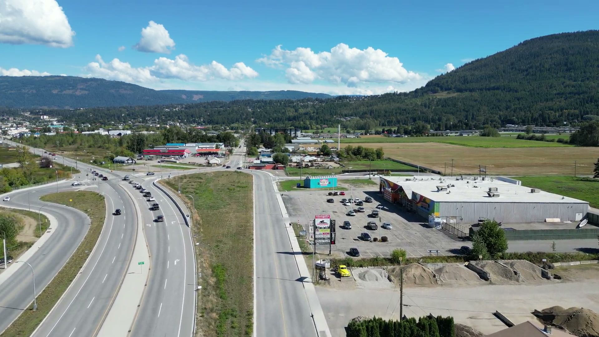 High over the four lanes of Highway 1 at the west side of Salmon Arm, pushing on toward the white roof and full lot of Westgate Public Market, the valley and the town beyond