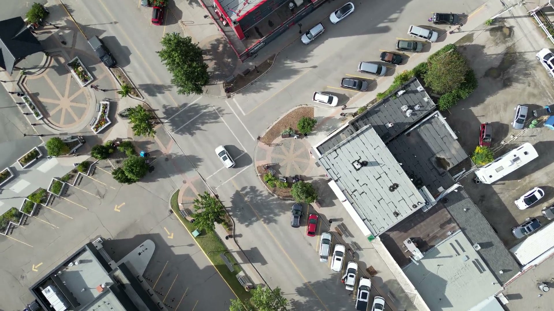 1st Street West from directly overhead: angled stalls, crosswalks and the brick circles set into the sidewalk