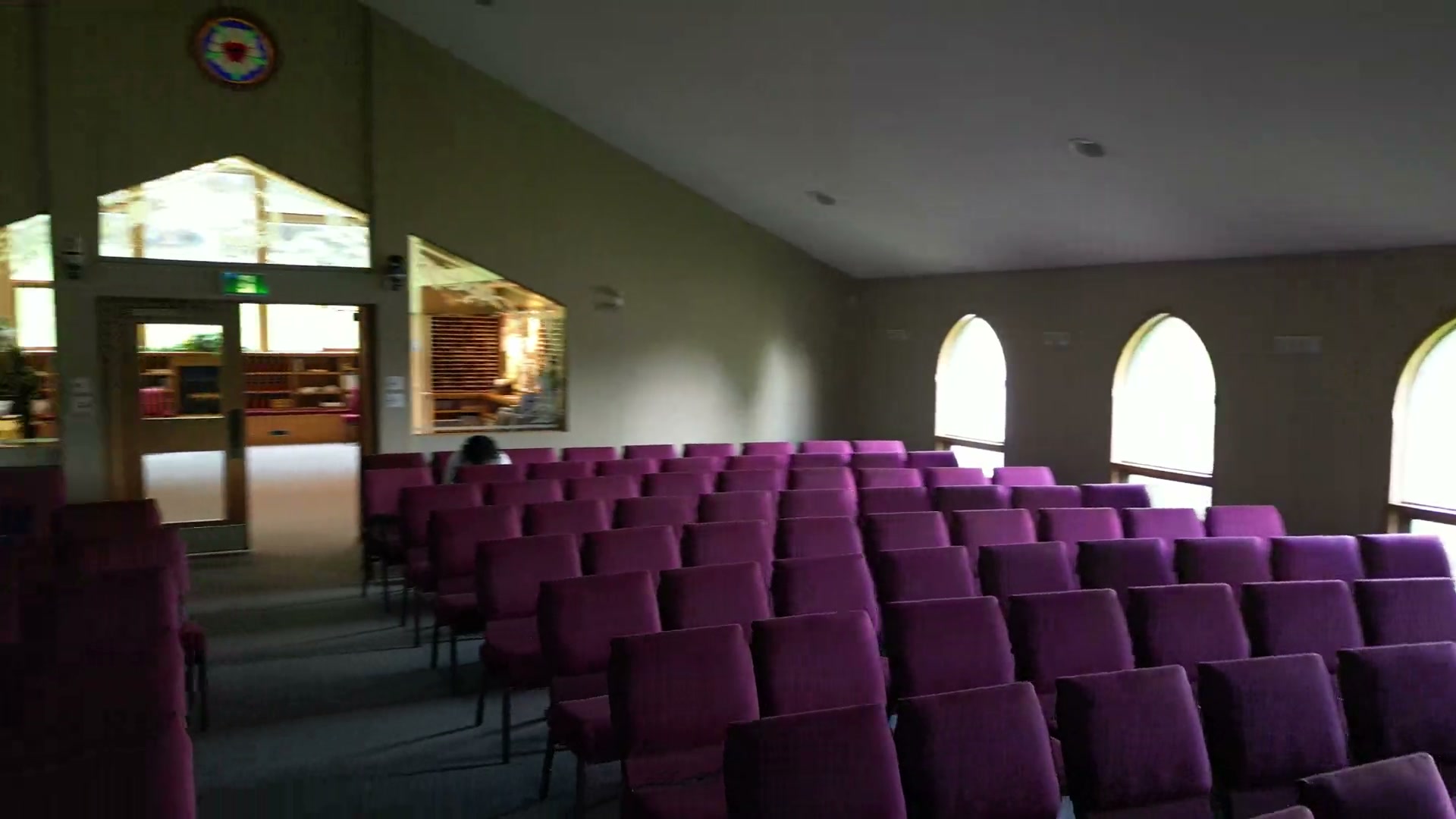 Turning from the chancel to the back of the sanctuary at St. Peter's, where Luther's seal is set in coloured glass high above the doors