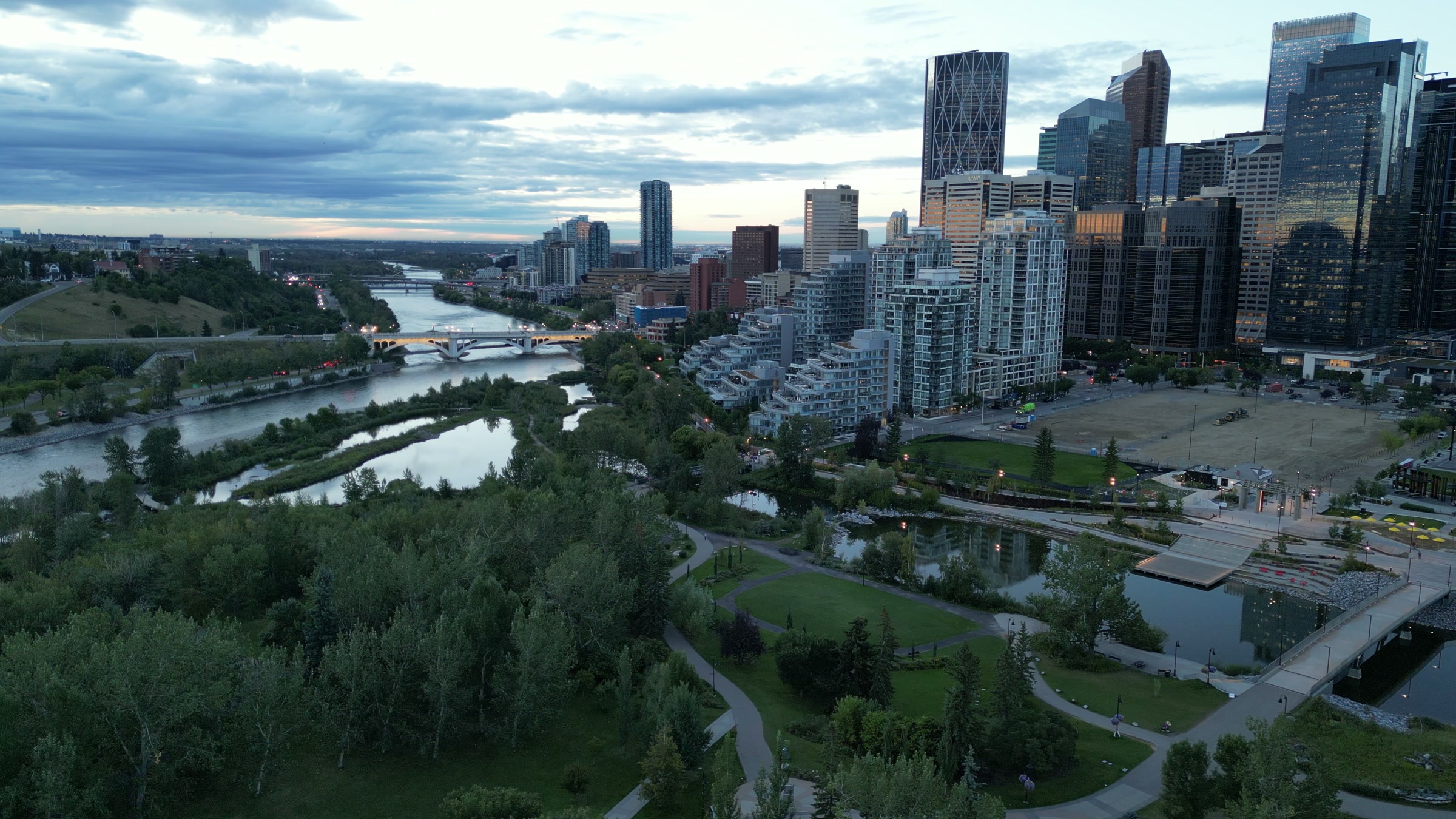 Downtown Calgary from above the Bow River at dusk, the towers catching the last light
