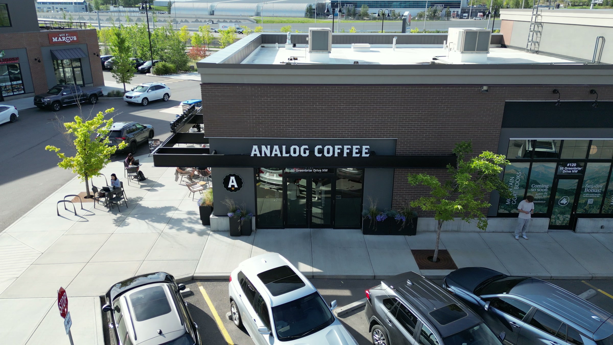 The café on its corner from above, the lot and the street around it