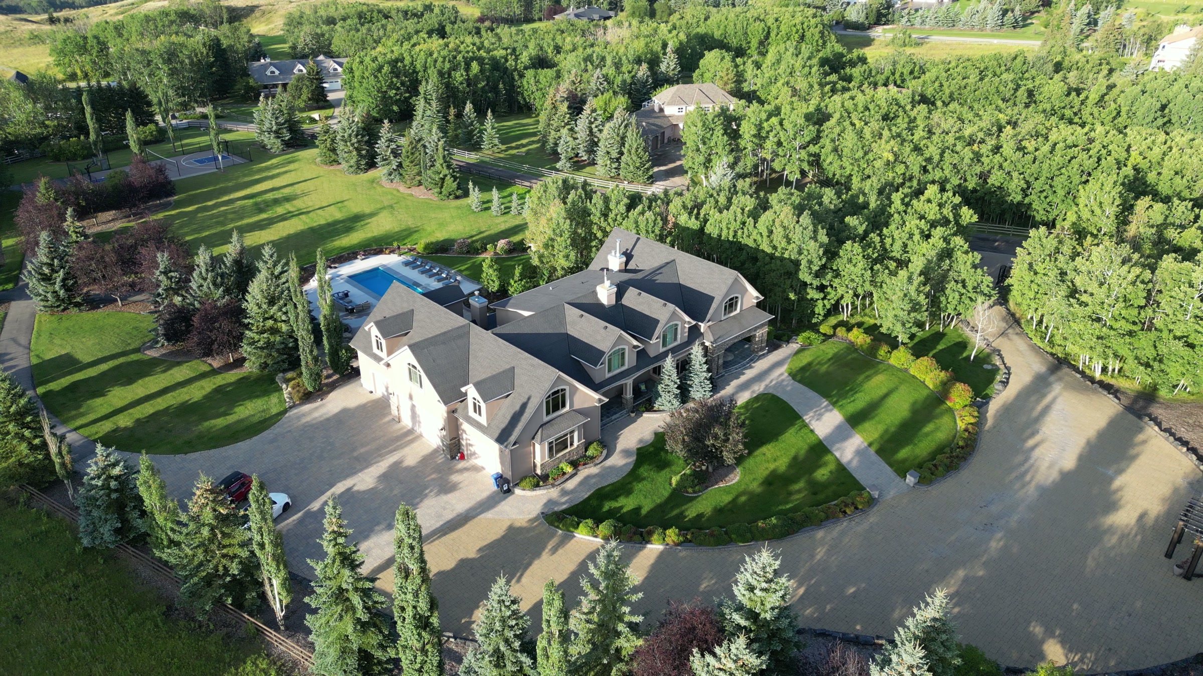 The estate and its circular drive within a stand of spruce and poplar