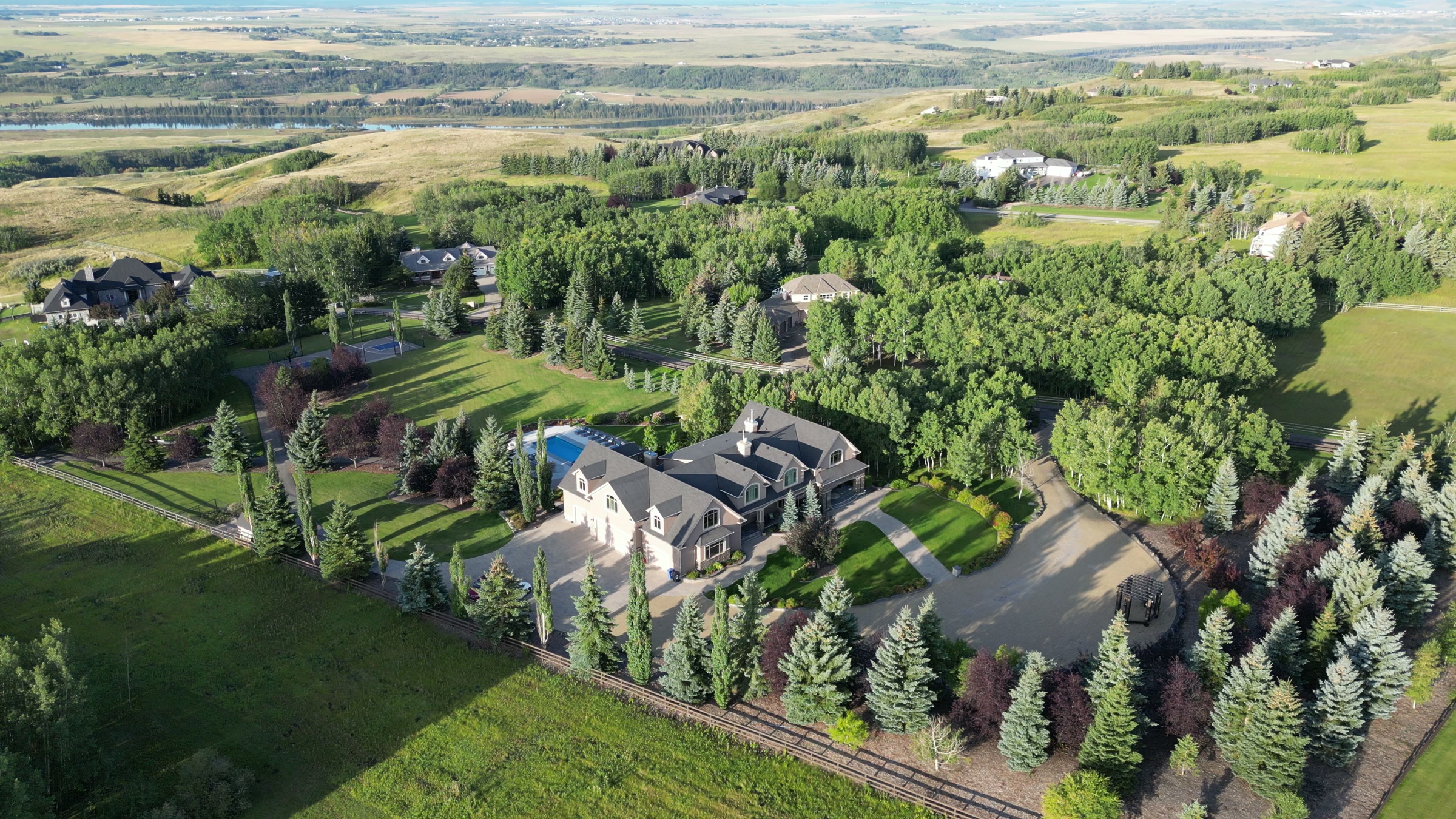 The whole property from altitude: house, pool, drive and the shelterbelt around it